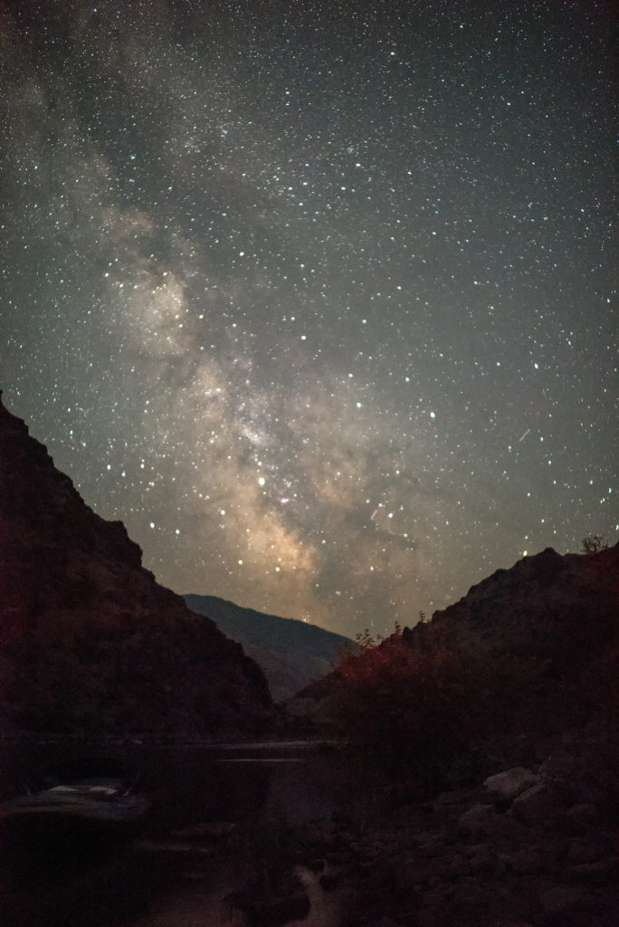 Nighttime sky full of stars against canyon walls during a Hells Canyon Whitewater Rafting Trip on the Snake River