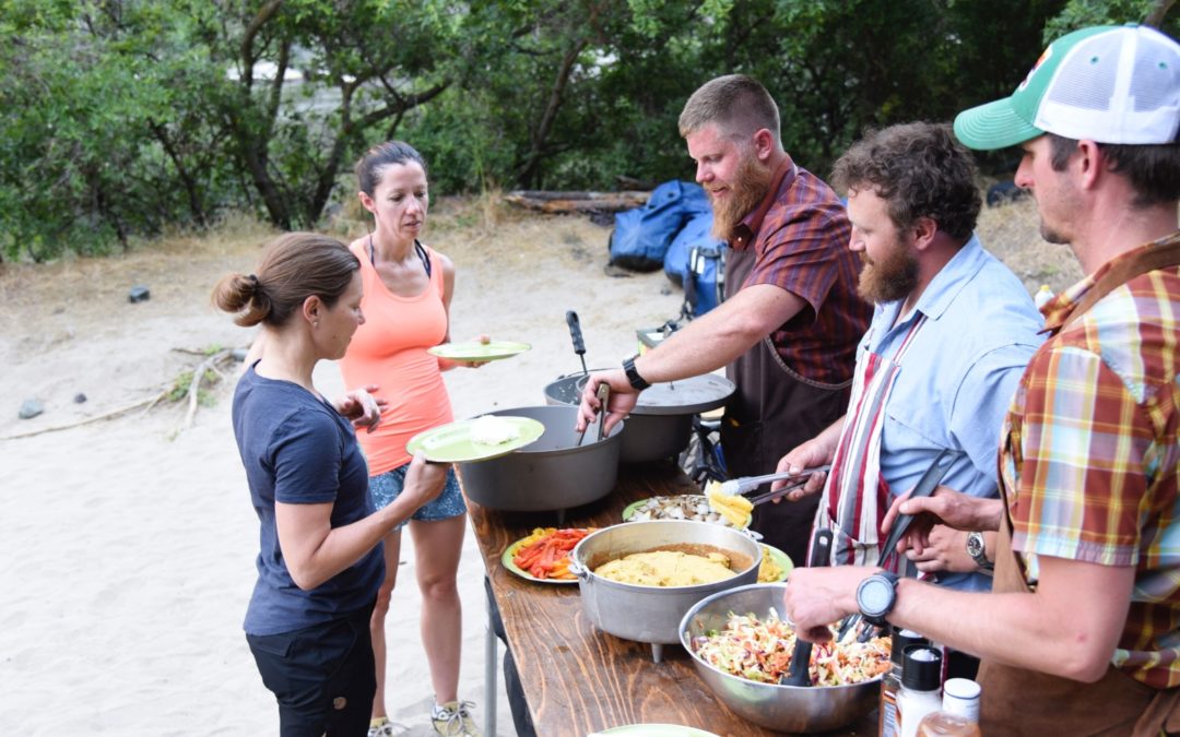 rafting guides serve dinner on a snake river whitewater rafting trip